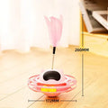 Pink cat tumble turntable toy with attached cat stick for interactive play