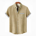 Man wearing a loose-fit linen short sleeve shirt with an ocean fish print on the lapel.