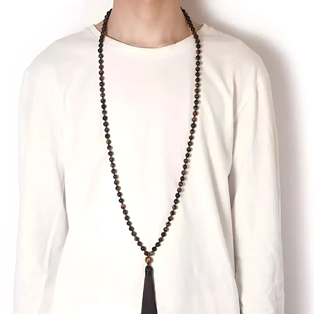 Geometric agate pendant necklace with colourful stone pattern and tassel detail on model
