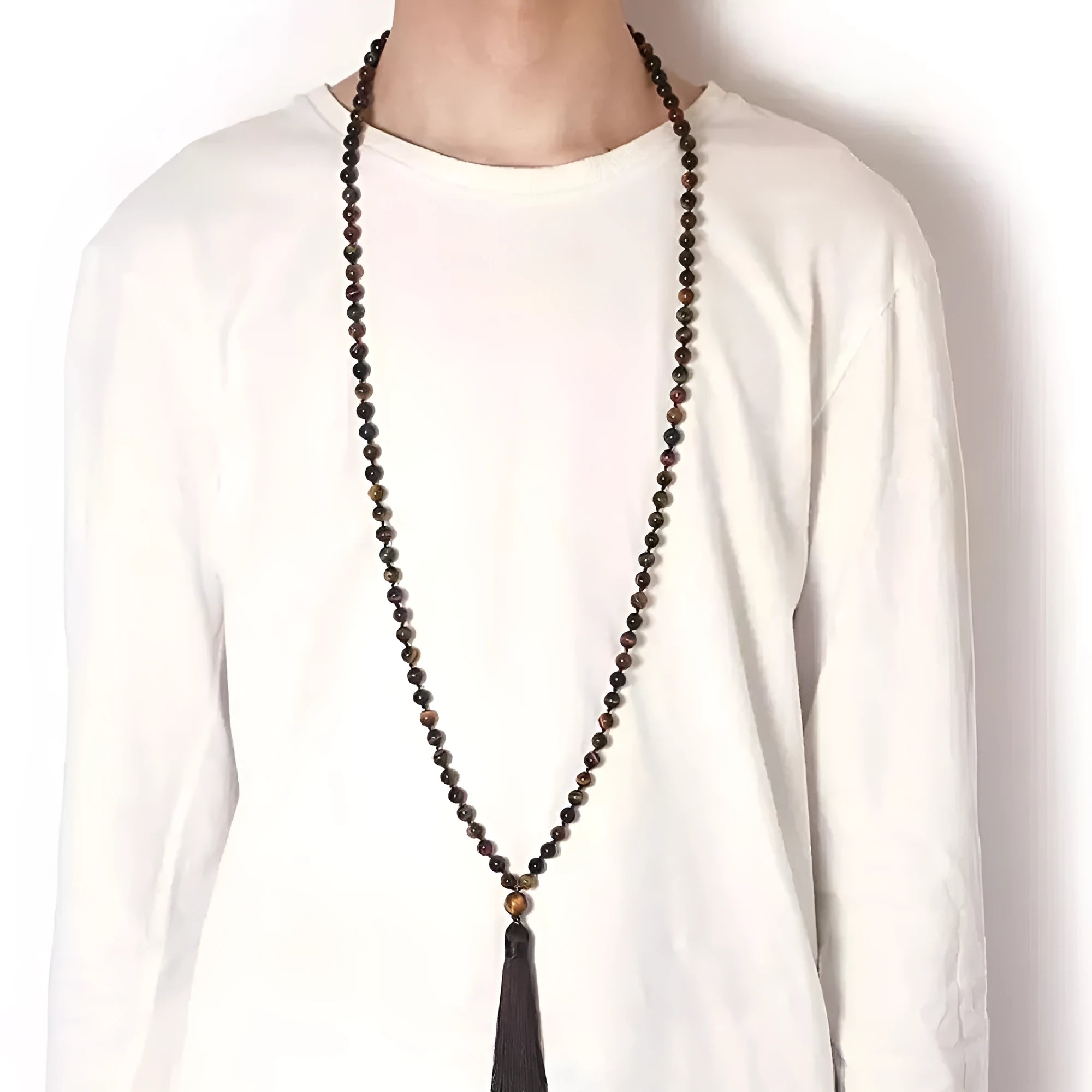 Geometric agate pendant necklace with colourful stone pattern and tassel detail on model