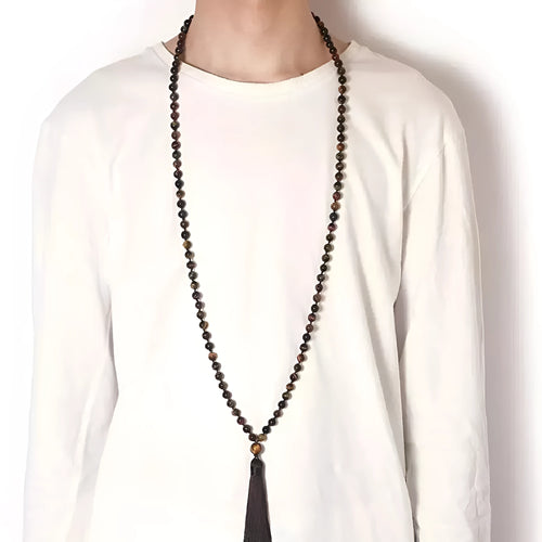 Geometric agate pendant necklace with colourful stone pattern and tassel detail on model
