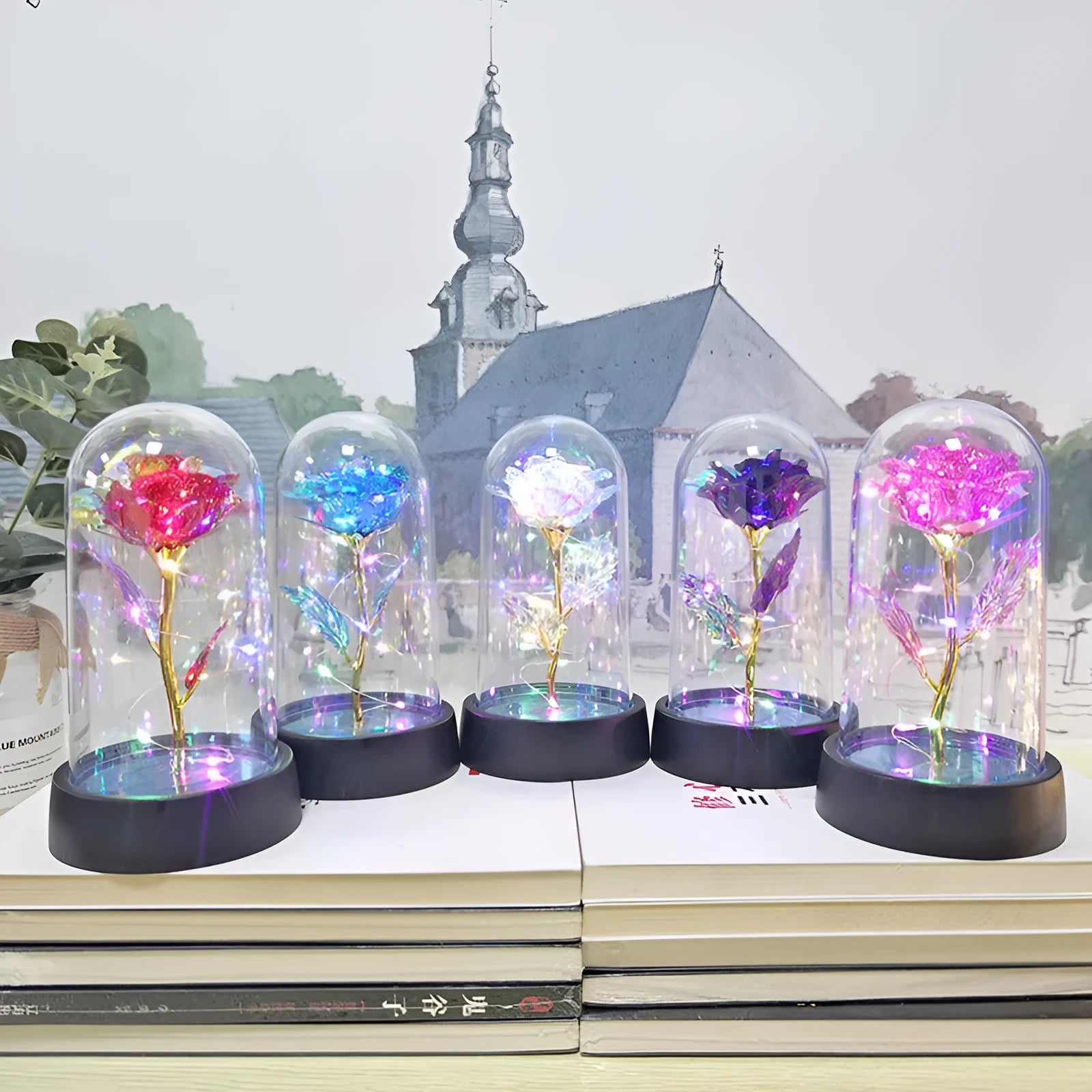Small glass night lamp with plastic flowers on a black base.