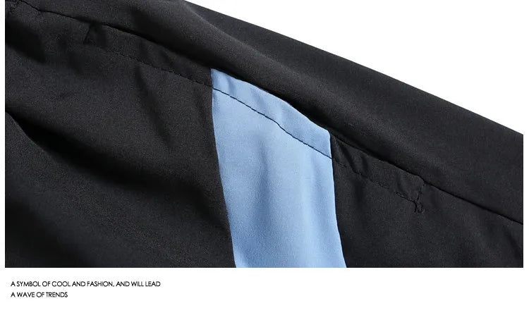 Men's black loose fit sports shorts with elastic waistband and contrast trim, shown on a hanger.