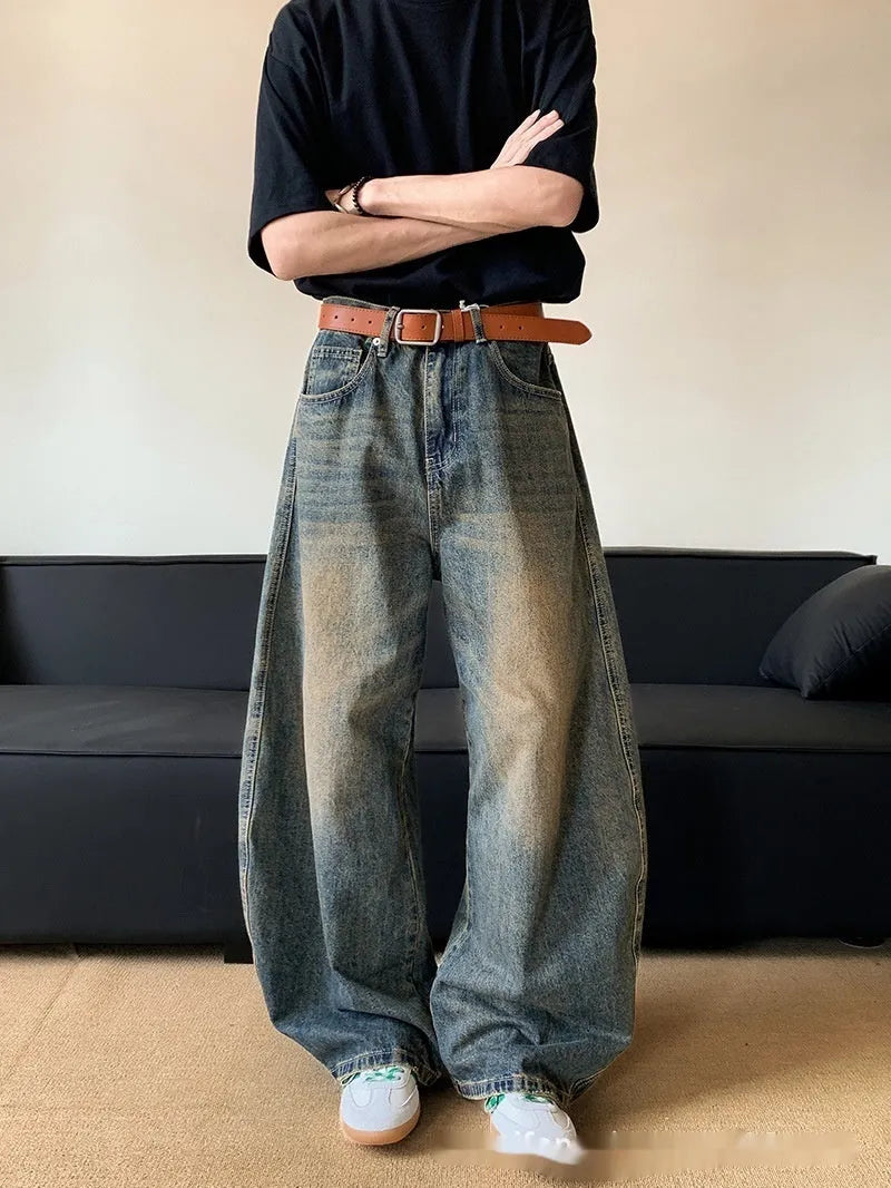 Men's retro blue distressed denim wide-leg trousers showing distressed detailing and wide-leg silhouette