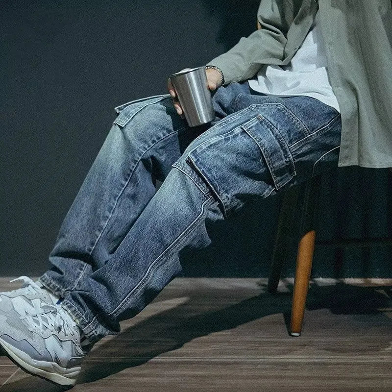 Man wearing blue loose straight-leg retro style stretch denim pants.
