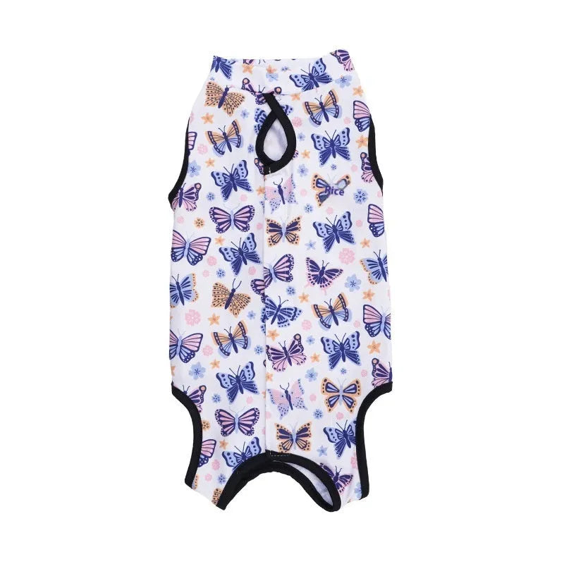 Cat wearing a blue patterned post-surgery sterilization recovery suit with Velcro closures.