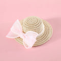 Pet cat wearing a woven Lafite leaf straw hat with a pearl butterfly decoration.