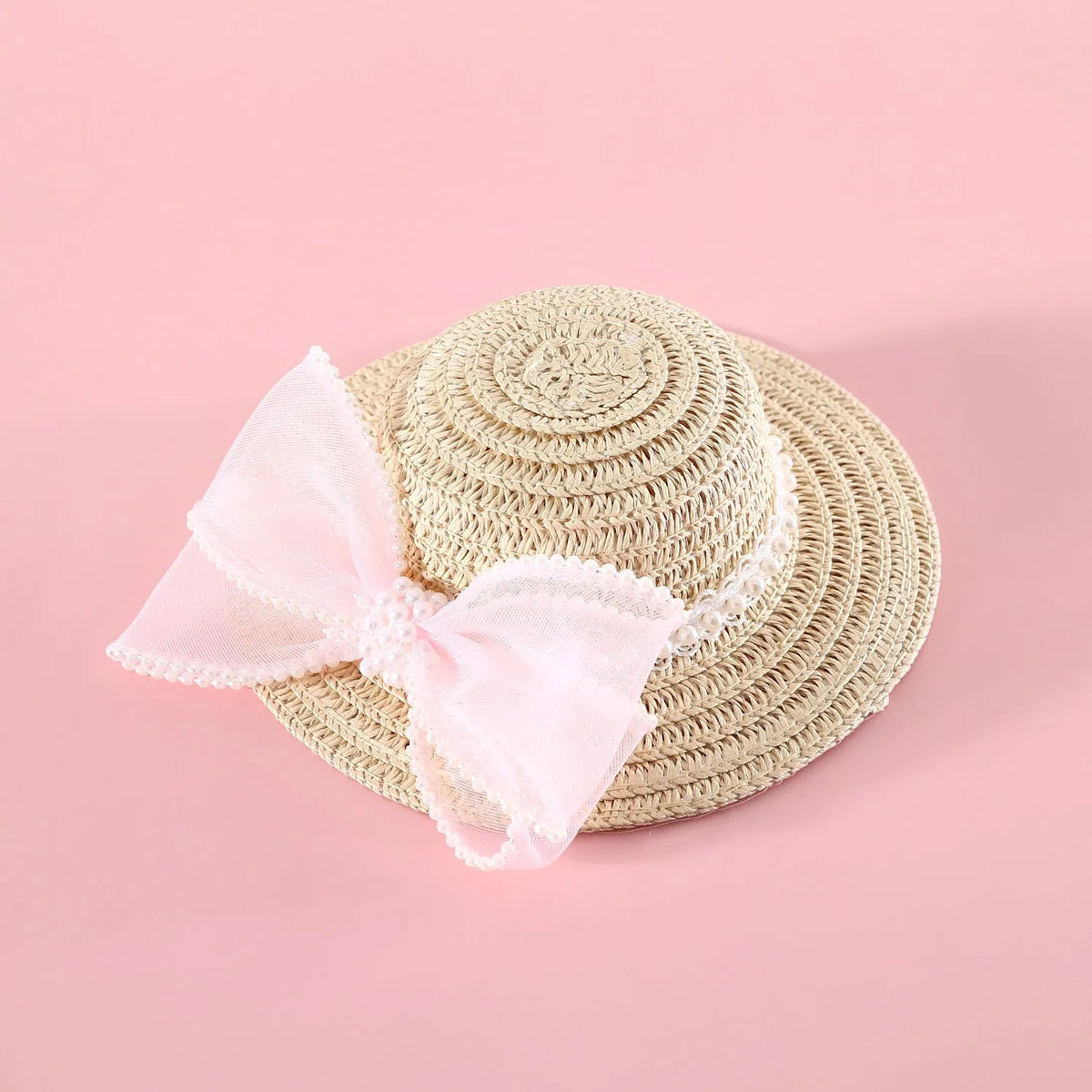 Pet cat wearing a woven Lafite leaf straw hat with a pearl butterfly decoration.