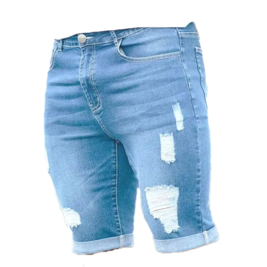 Men's sky blue denim shorts with multi-hole distressed design showing low waist and straight cut