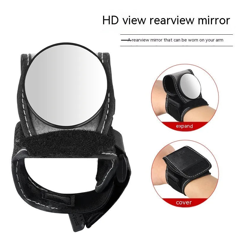 Black nylon wrist-mounted bicycle rear-view mirror with velcro strap and armoured glass reflective surface.