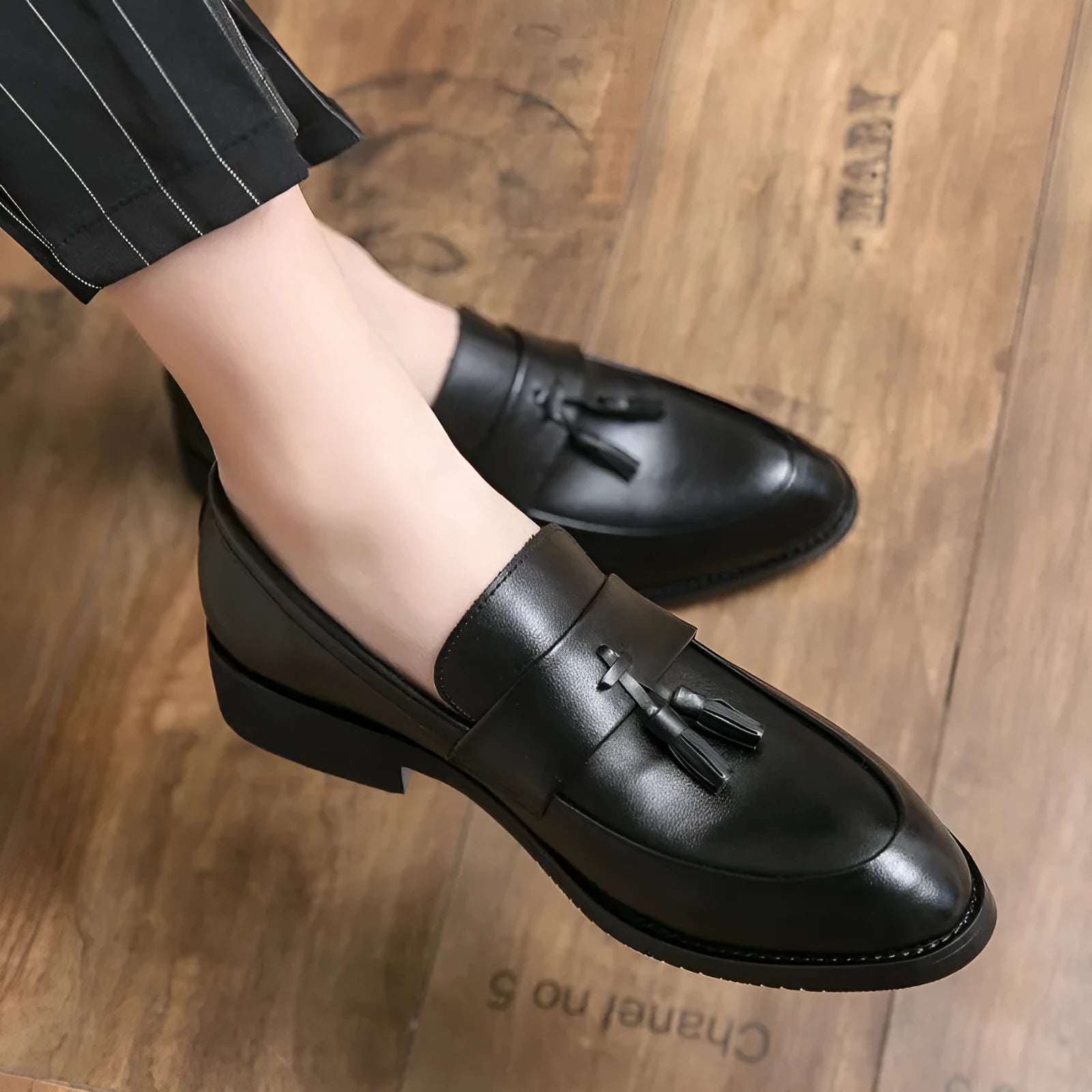 Men's black slip-on business casual shoes with tassel detail and rubber soles