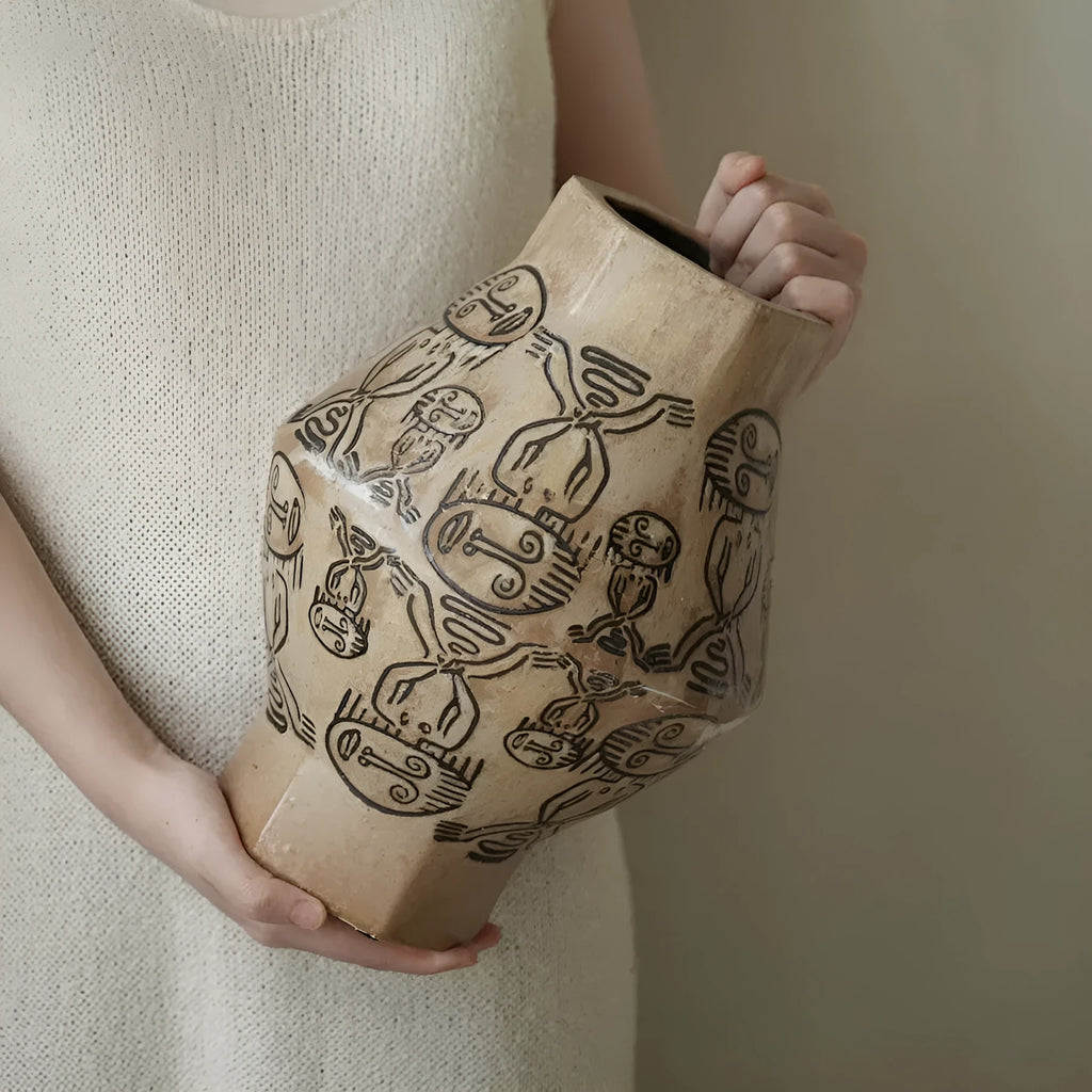 Hand-painted ceramic vase with tribal totem patterns in cylindrical shape