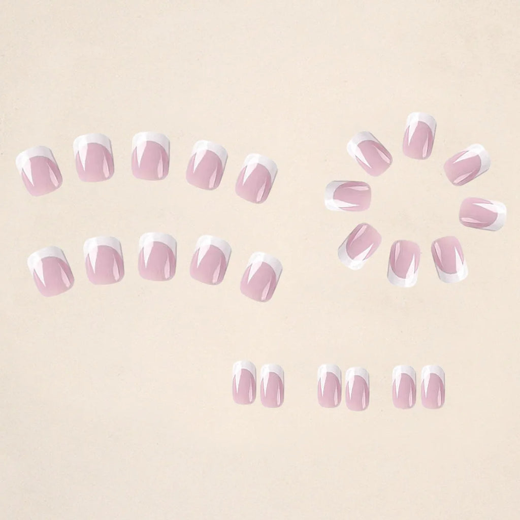 24 white false nail tips with a black and white plaid pattern, arranged on a card.