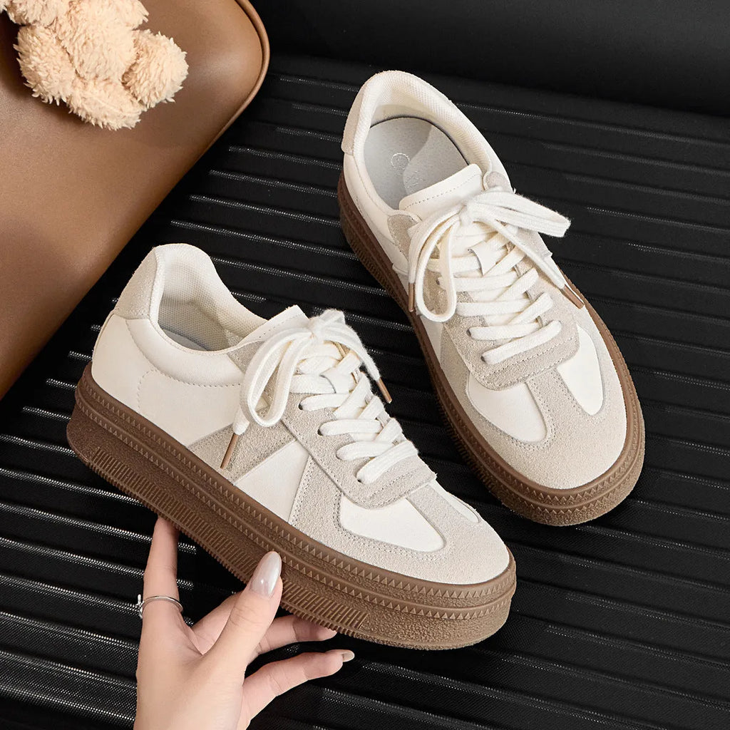 Retro-style silver board shoes with cross straps and round toe on a rubber sole.
