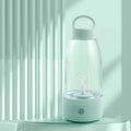 Automatic electric shaker bottle with USB port, handle, and blending motor in green, pink or white.