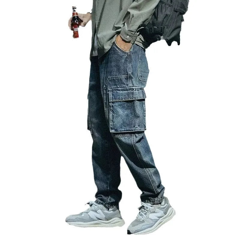 Man wearing blue loose straight-leg retro style stretch denim pants.