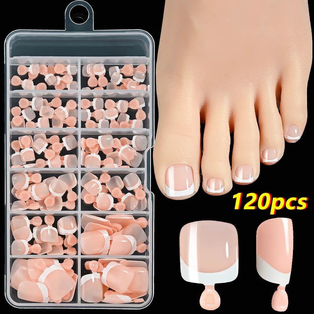 120 piece box of square short French style artificial toe nails with white tips on nude base.