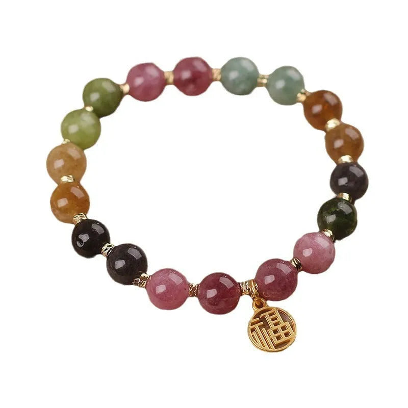 Natural tourmaline bracelet with flower and Fu charms on silver-tone electroplated brass.