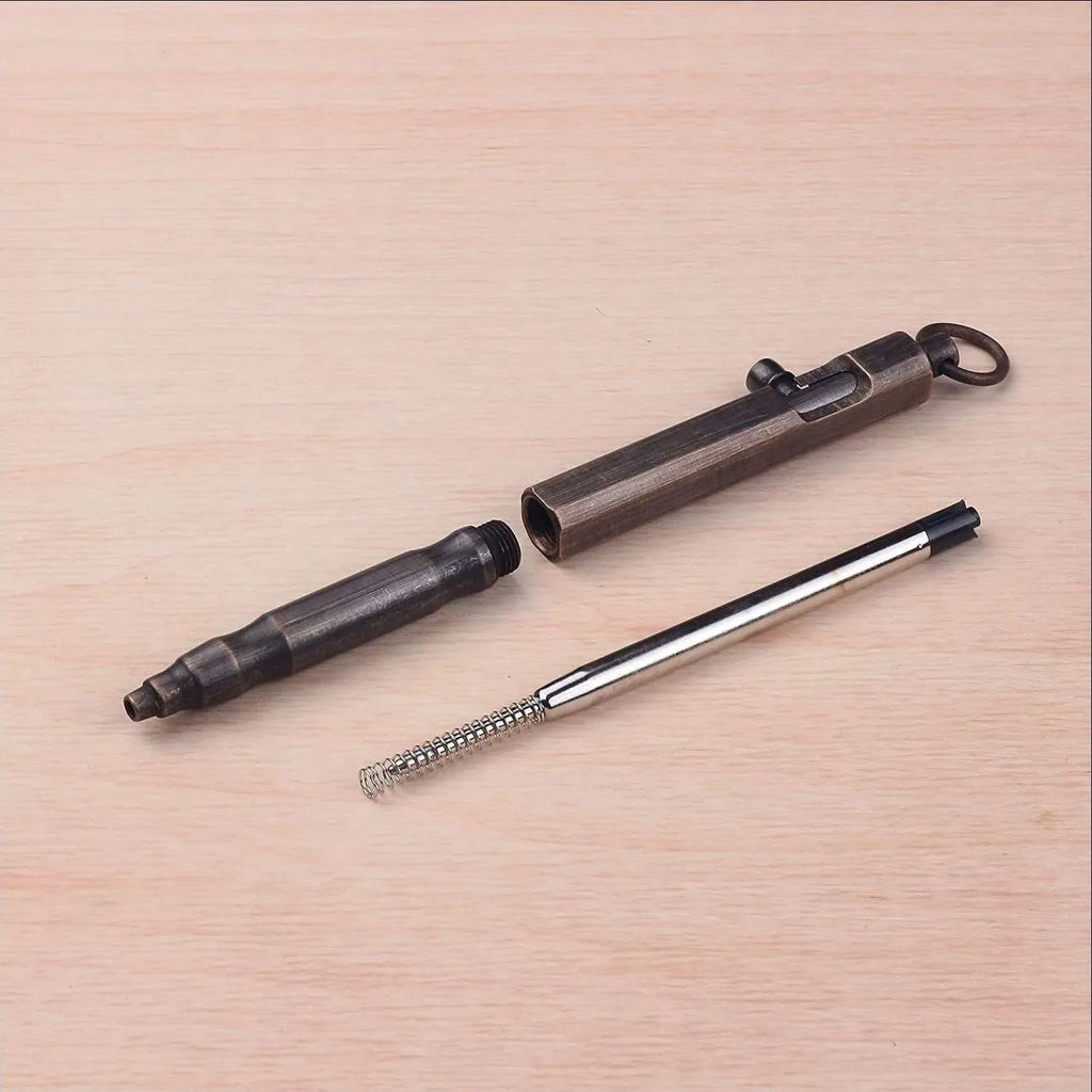 Brass hexagonal bolt tactical pen with machine gun design in natural brass or vintage black finish.