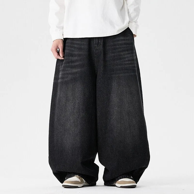 Men's plus size baggy jeans in dark blue denim with a straight leg opening and low waist.