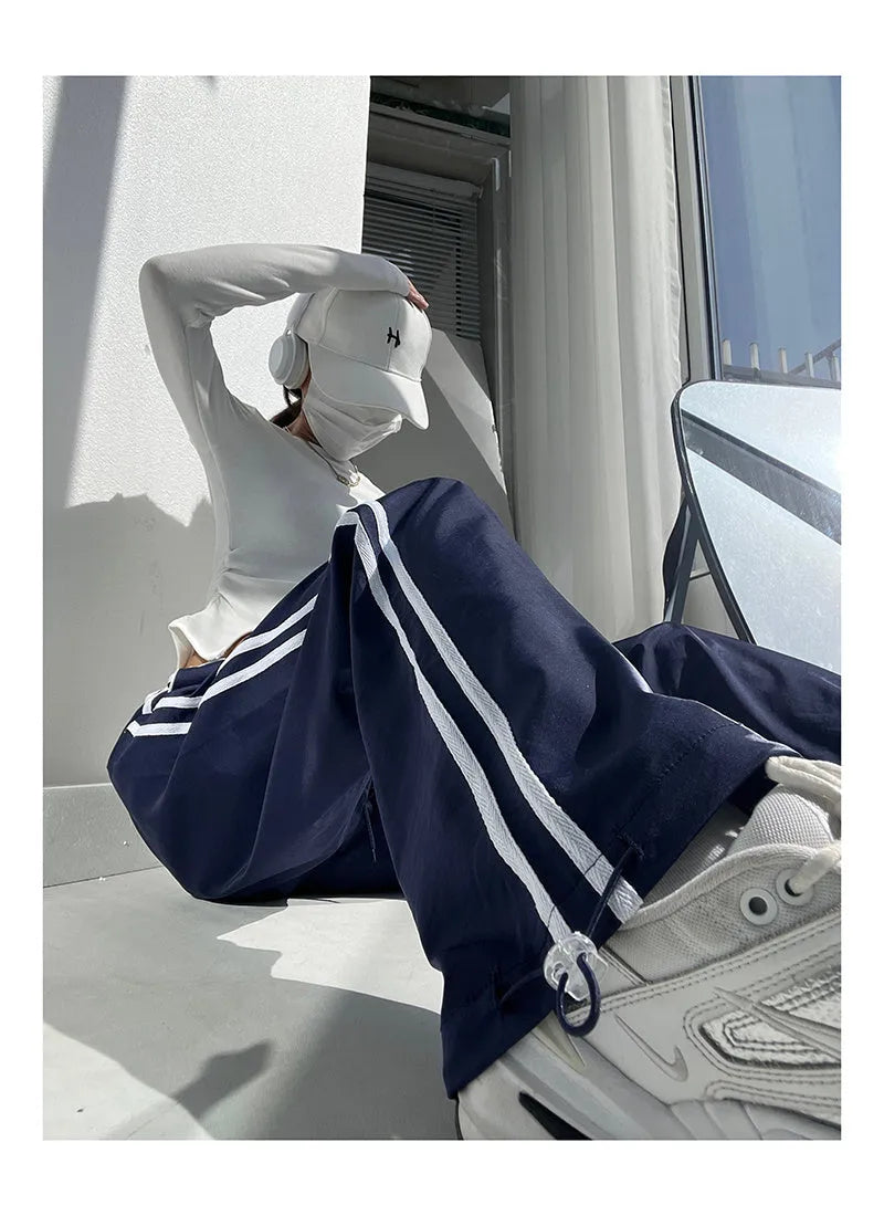 Women's slim drape trousers with contrast ribbon parallel bars detailing and loose straight leg cut