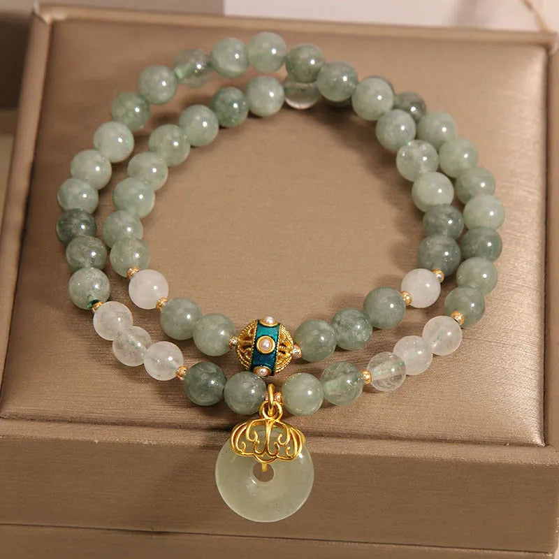 Women's green double-layer crystal bracelet with a peace buckle clasp and rhinestone details.