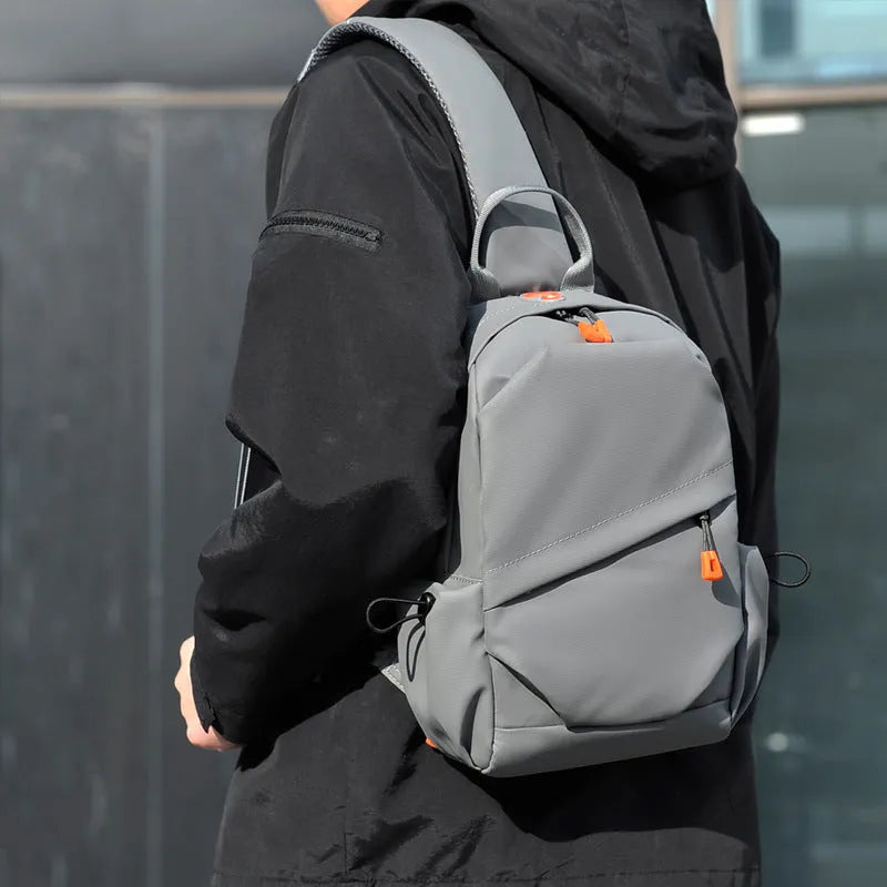 Men's black casual crossbody bag with an adjustable shoulder strap made from waterproof polyester.