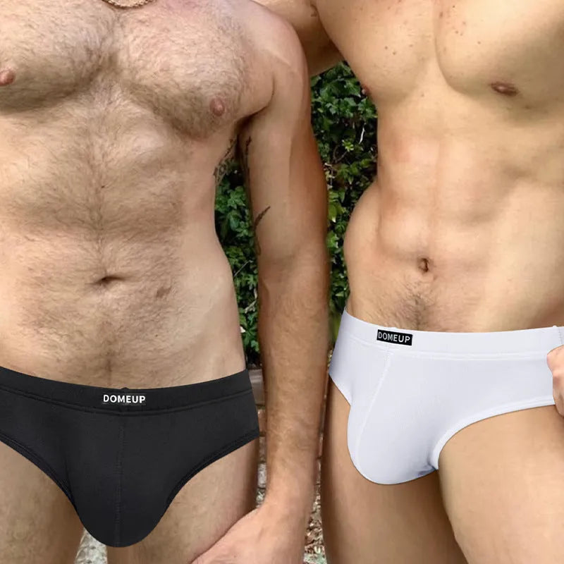 Men's solid colour low-waist briefs in white, black, or pink with seamless construction