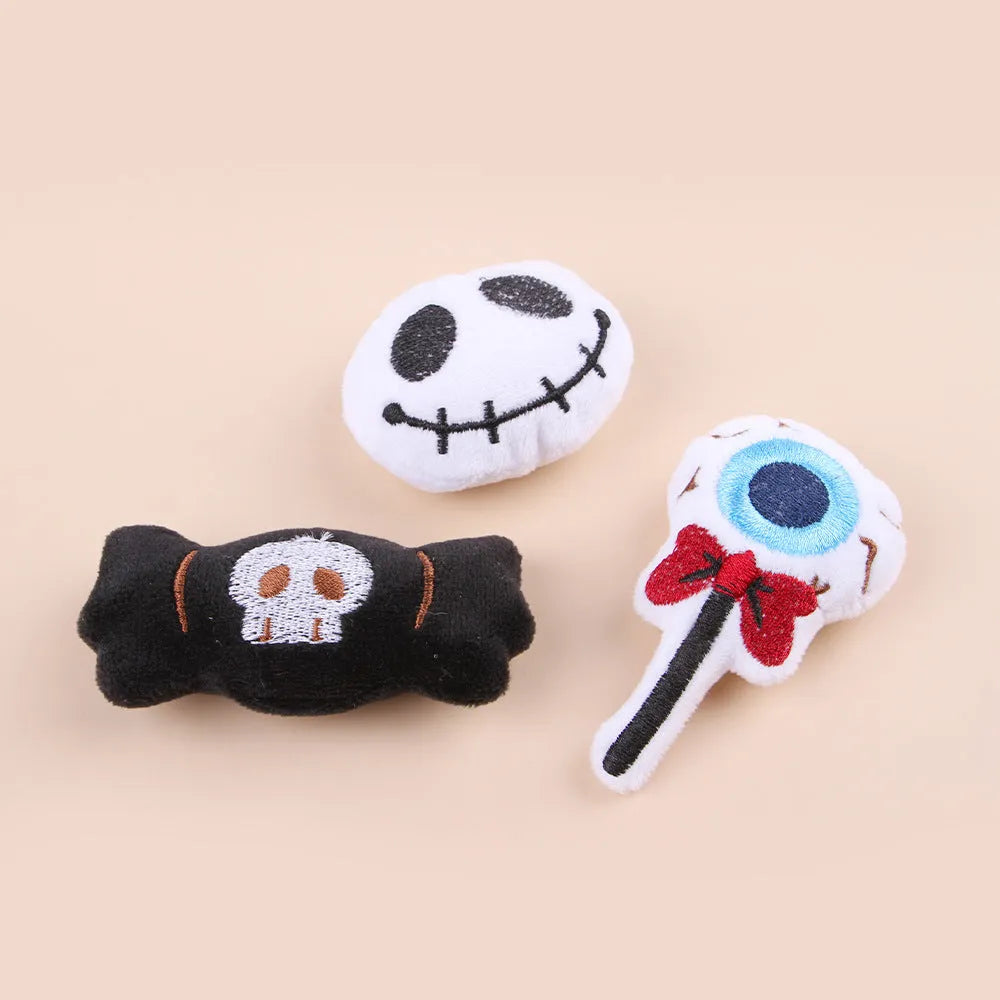 Small colourful plush cat teaser toy with candy, eyes and skull attachments