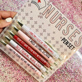 Set of five white nurse theme ballpoint pens with retractable tips.