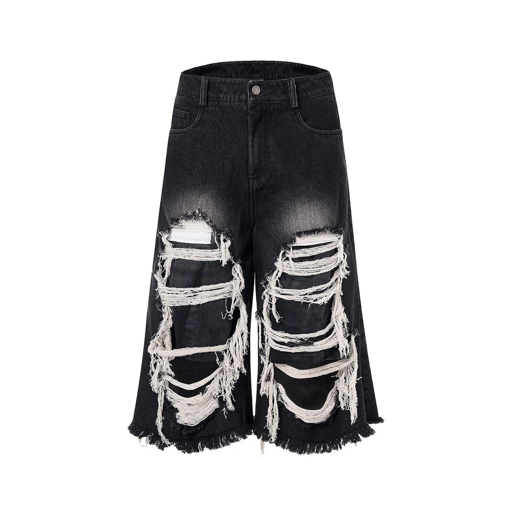 Black women's cropped wide-leg jeans with ripped patch details on a mid-high waist.