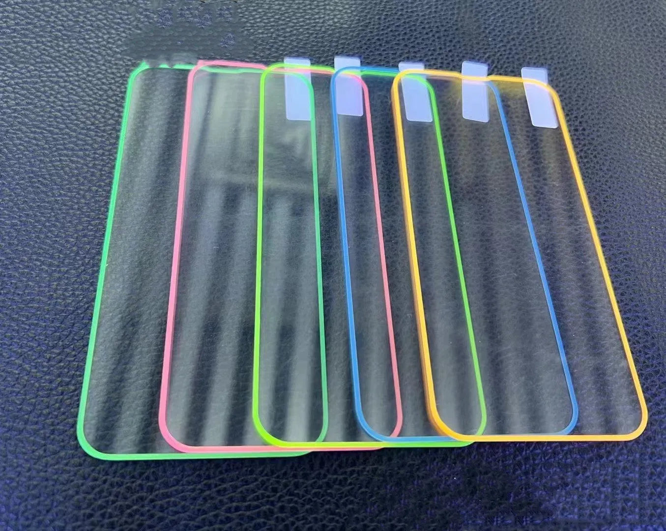 Fluorescent tempered glass screen protector for iPhone showing luminous glow in blue colour