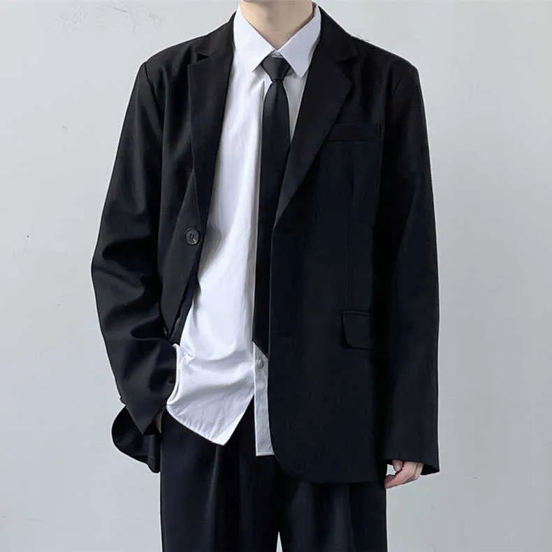 Plus size man wearing a navy college style suit jacket and trousers with a white shirt and blue tie.