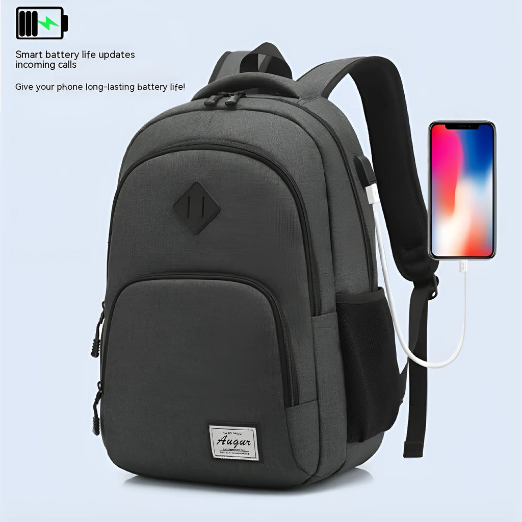 Grey lightweight nylon backpack with USB charging port shown on a trolley suitcase.