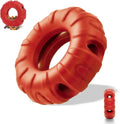 Beef-flavoured red rubber tyre dog chew toy with oval openings for treat dispensing