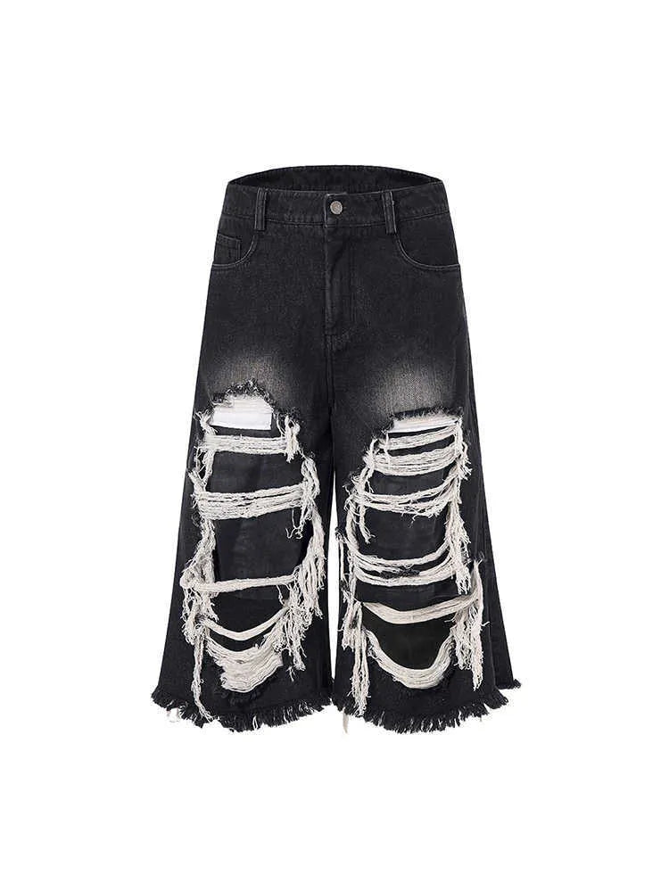 Black women's cropped wide-leg jeans with ripped patch details on a mid-high waist.