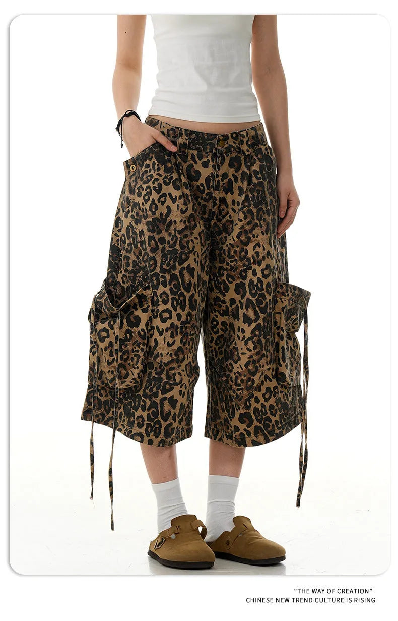 Leopard print cotton cropped trousers with a high waist and straight leg on a hanger