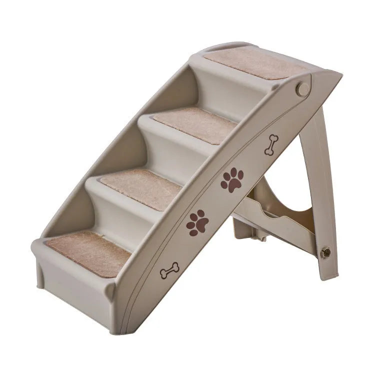 Foldable grey plastic pet stairs for small dogs and cats placed next to a sofa, showing non-slip mats on steps.