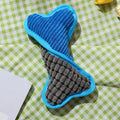 Blue teddy dog toy with a squeaker bone model, showing soft plush and corn fleece lining.