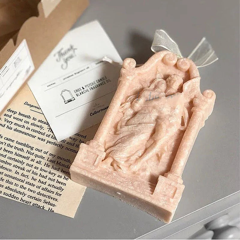 Flexible food grade silicone mold showing detailed Ancient Greek-style couple angel design for baking and crafts.