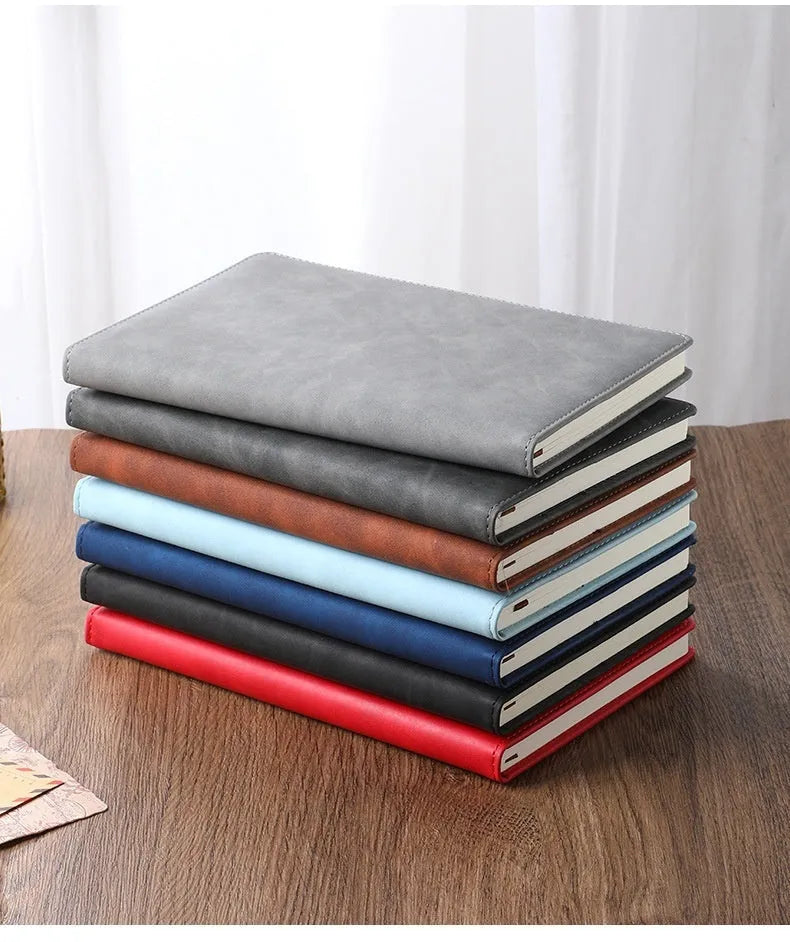 A5 notebook with PU leather cover shown in multiple colour options including black, red, green, blue, and orange.
