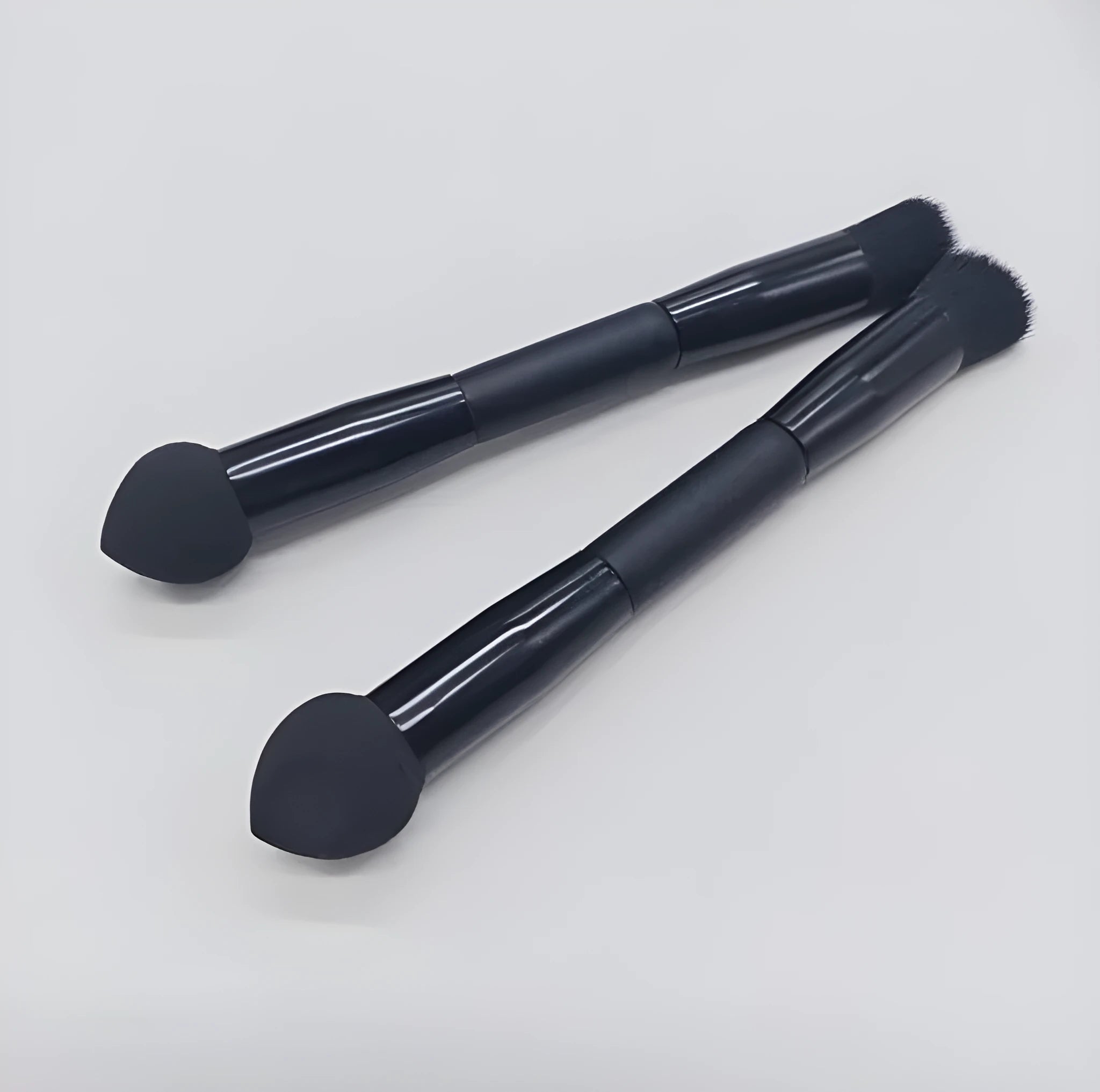 Double-headed makeup brush with miter sponge tip and artificial fibre bristles on wooden handle