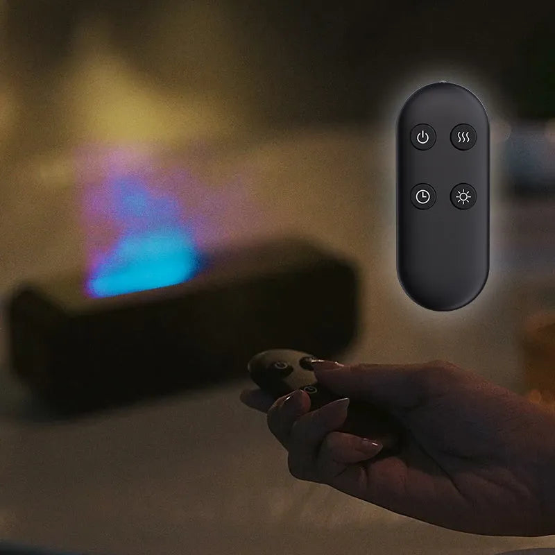 Black and white USB aroma diffuser with remote control and colour-changing lights on a wooden surface
