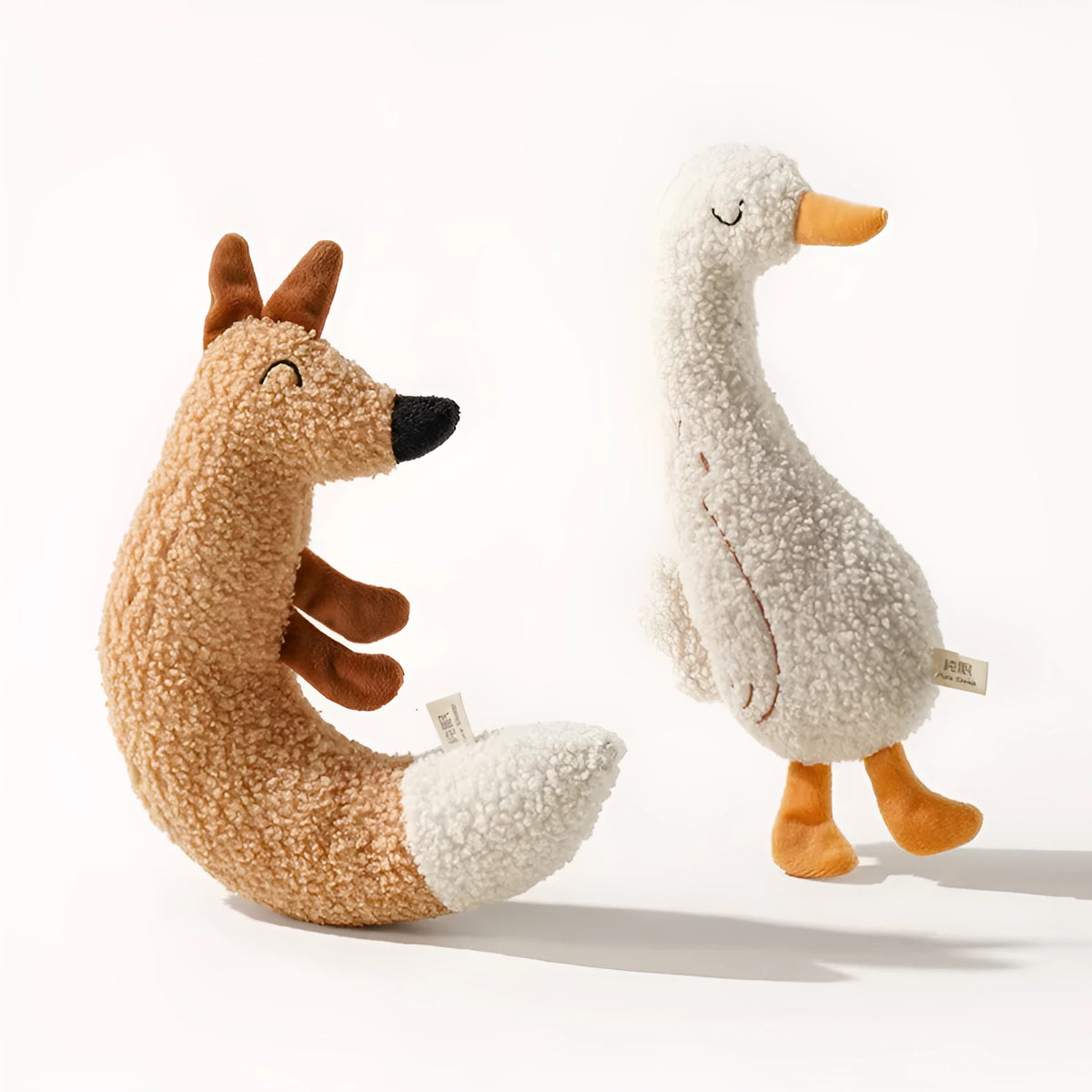Cartoon dog chew toy in teddy velvet fabric, shown as a duckling and a fox character on a white background.