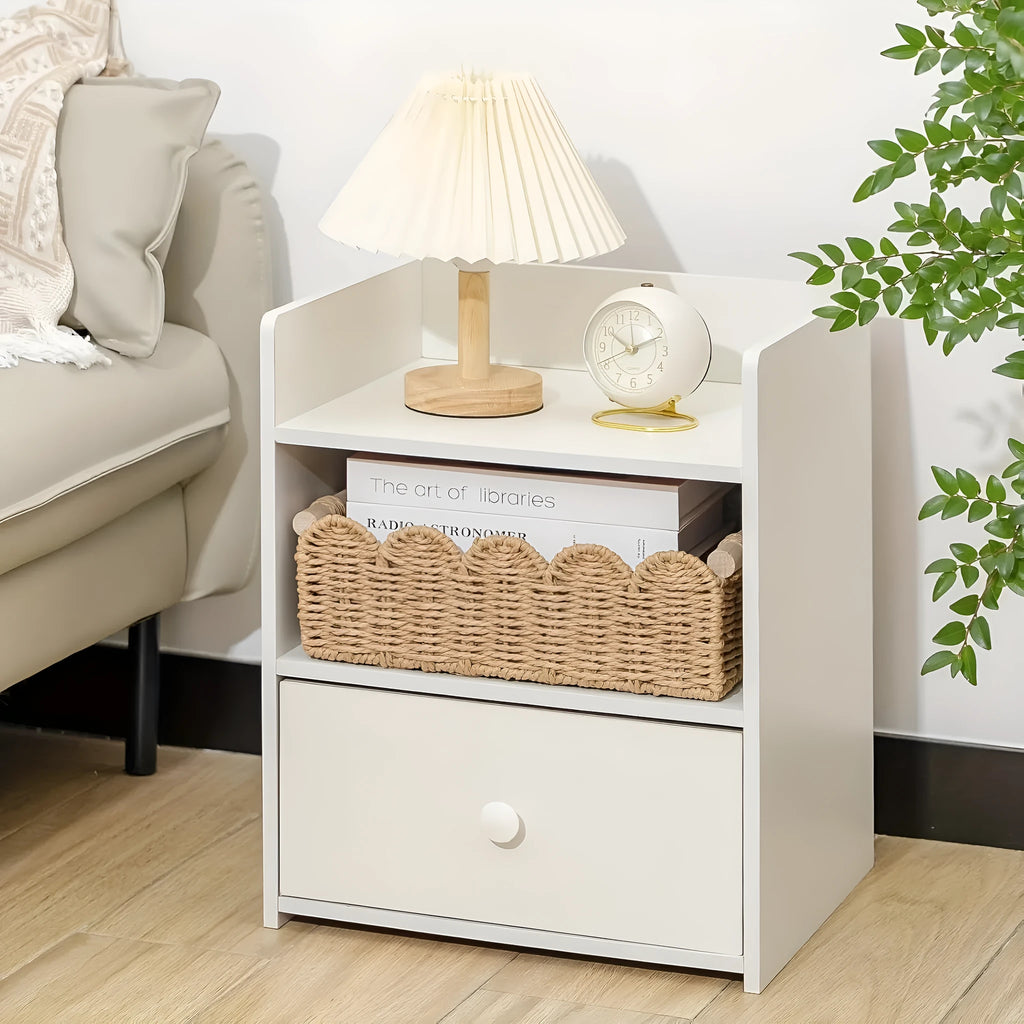 Modern simple woven paper storage basket in neutral colour on a wooden desktop holding remote controls and pens.