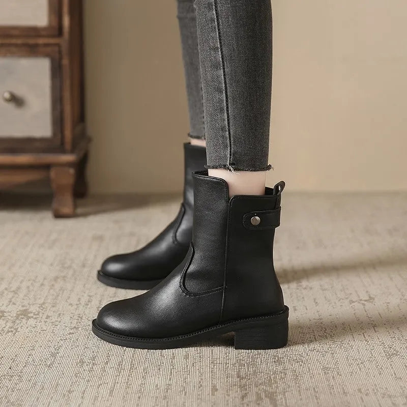 Black women's low heel ankle boots with a side zip and round toe.