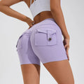 Women's high-waist fitness shorts in quick-dry nylon with side pockets, shown in Electric Blue.