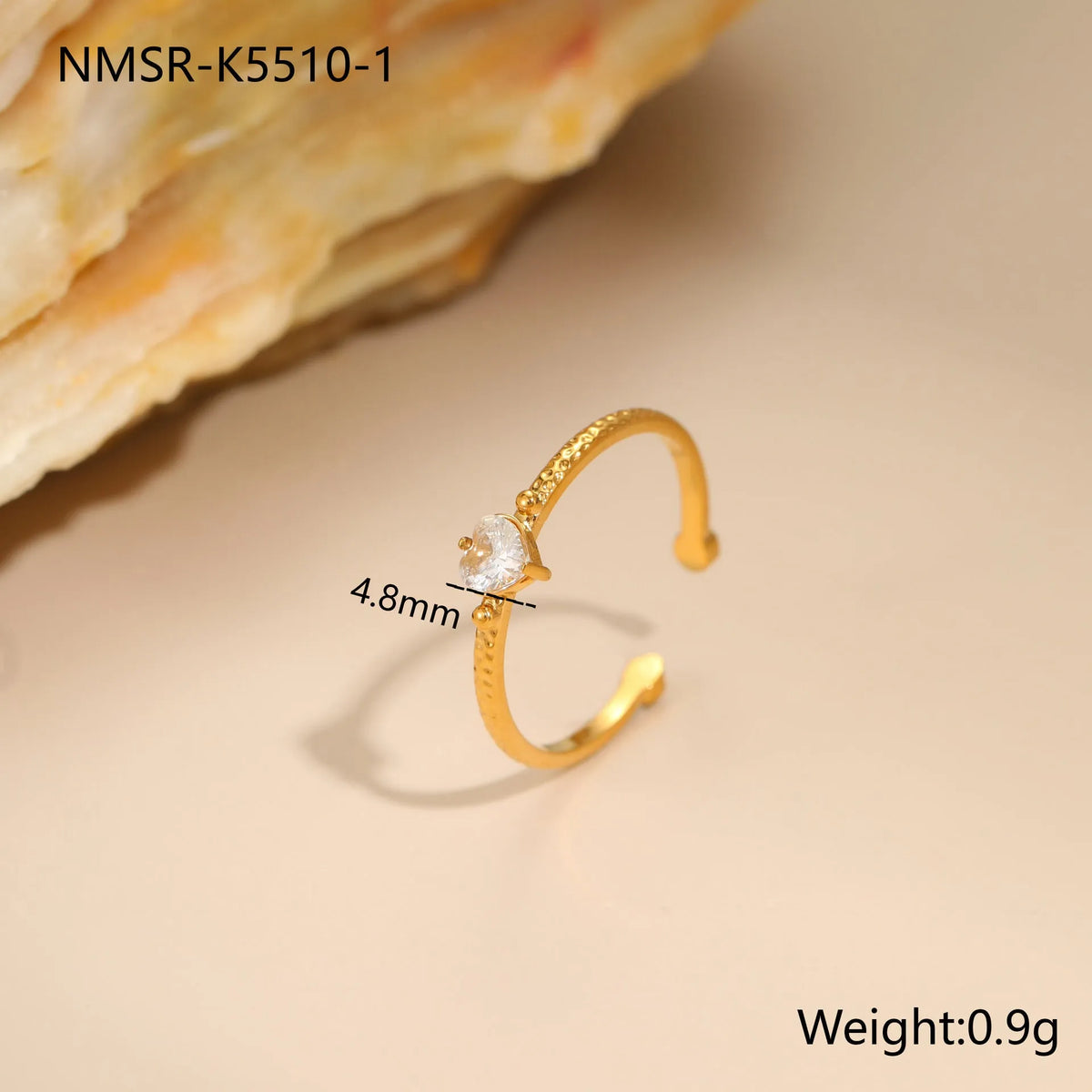 Open ended stainless steel ring with heart-shaped geometric centre and inlaid coloured zircon stone.