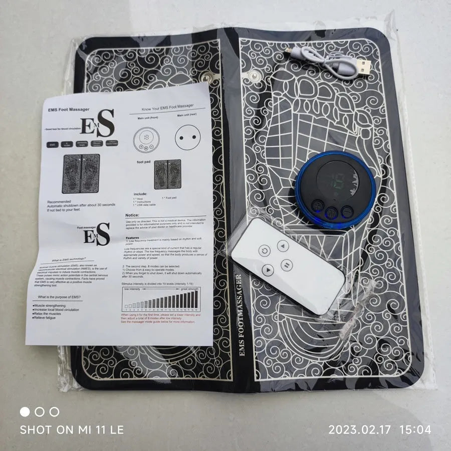 Leather foot massage cushion with remote control and LCD screen showing massage modes