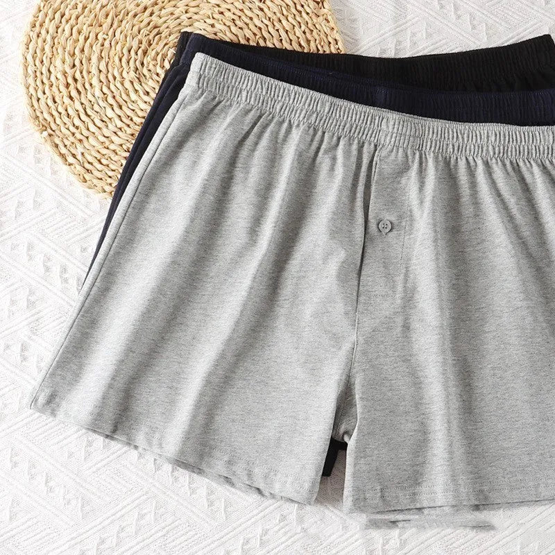 Men's loose-fit pure cotton boxer shorts in light grey, shown laid flat to display high-waist design.
